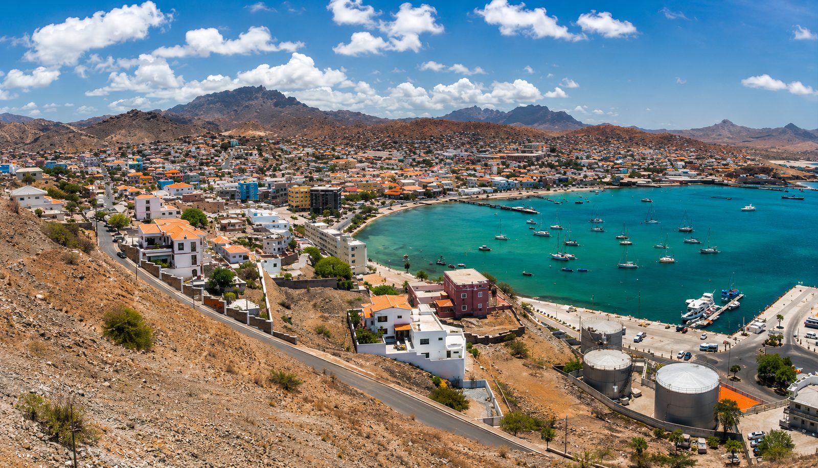 Aerial view of the pier and beach at Santa Maria on Sal at sunset, with fishing boats on turquoise water, Cape Verde