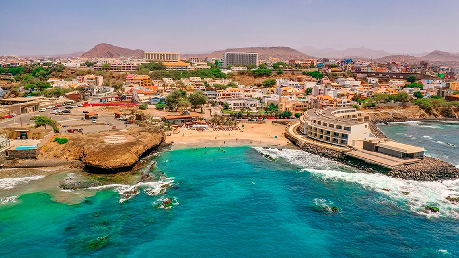 A beach resort with a pool and sun loungers at sunset, Cape Verde