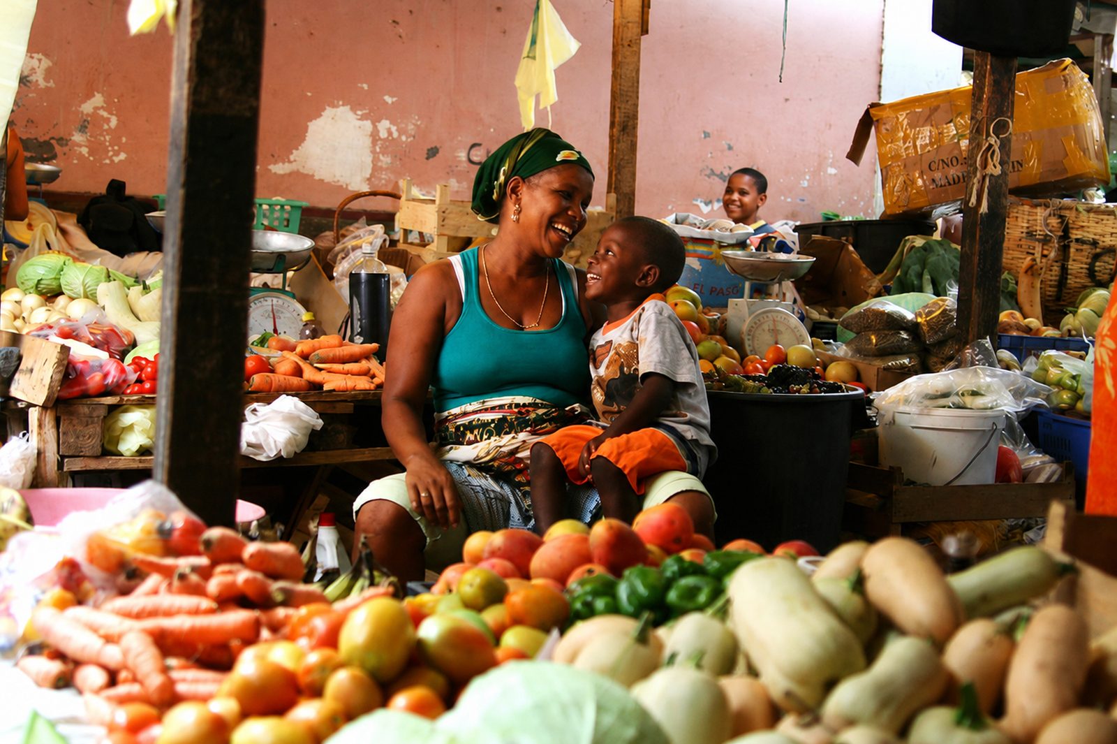 A cobbled old-town street in Cape Verde lined with craft and souvenir stalls and weathered colourful houses