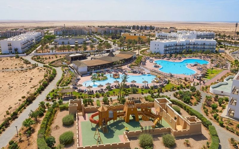 Meliá Dunas Beach Resort on Sal, Cape Verde, seen from above, with pools, a castle-themed children's playground and low white buildings