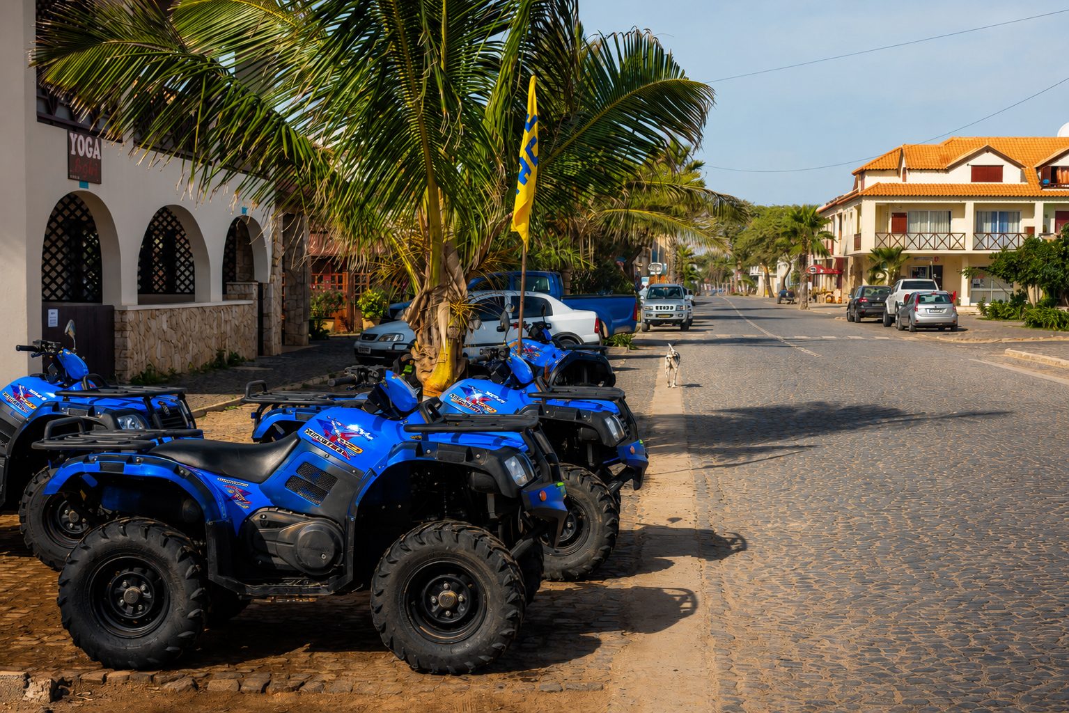 Blue quad bikes lined up on a cobbled street in Santa Maria, ready for an island tour on Sal