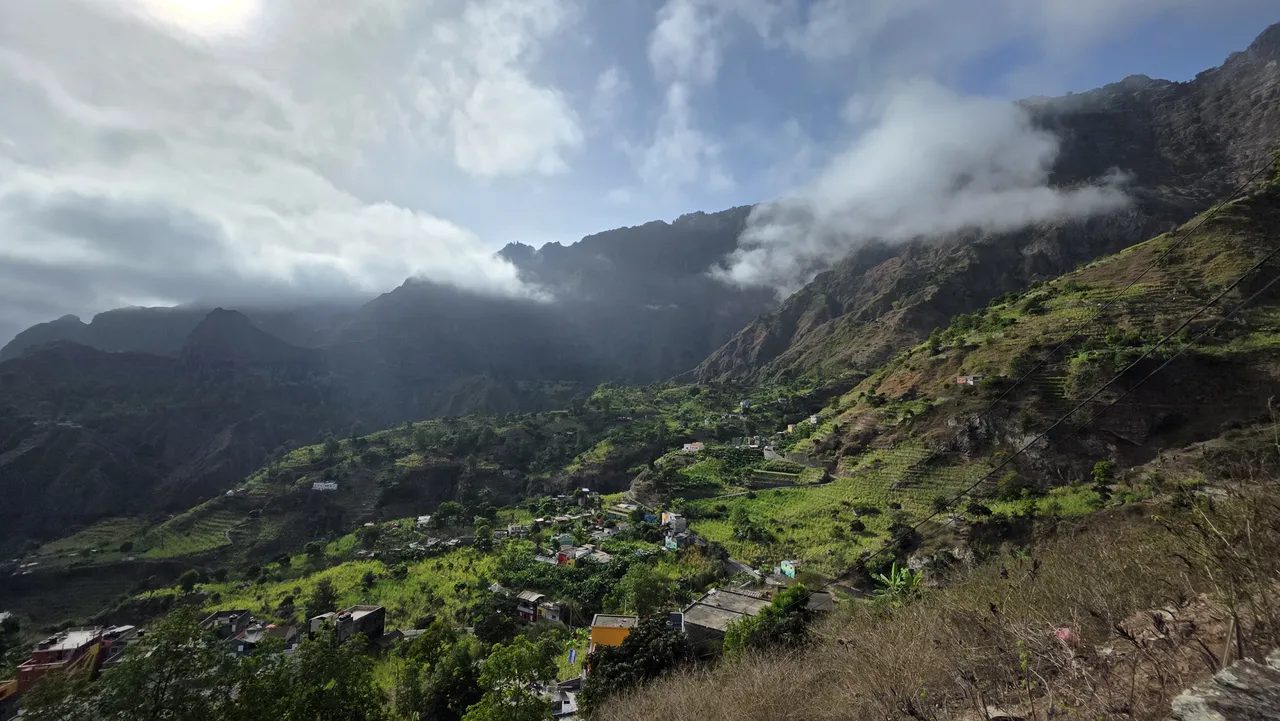 Villages and terraced fields spread across the upper Paul Valley under steep, cloud-topped mountains, Santo Antão